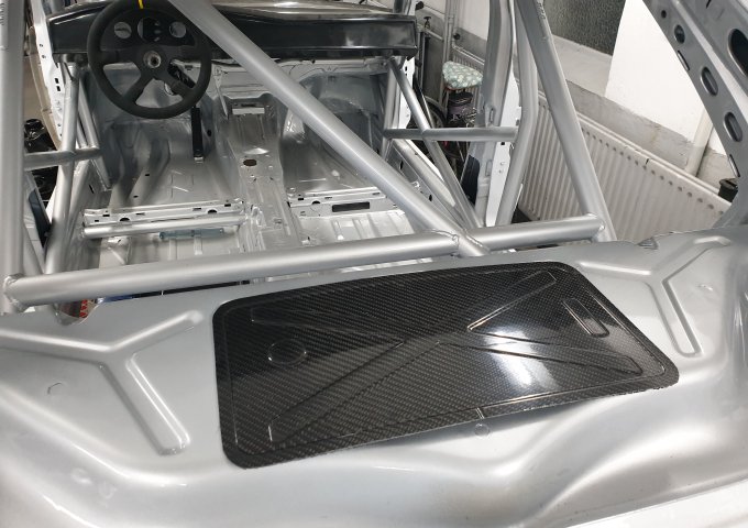 Carbon cover for rear fire wall